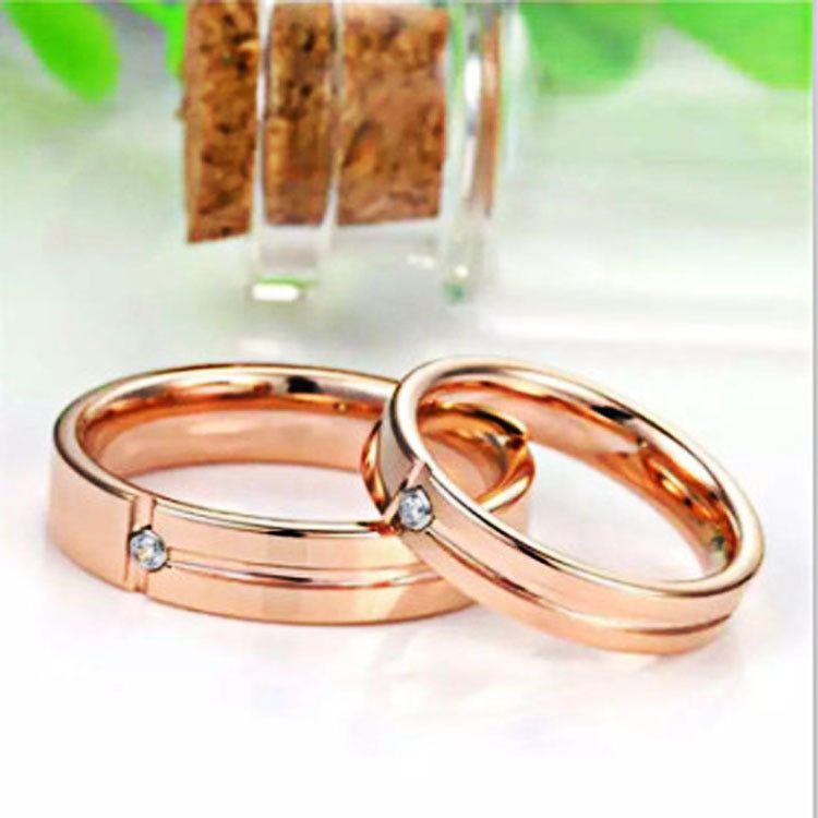 Two rose gold rings with small diamonds on a white background