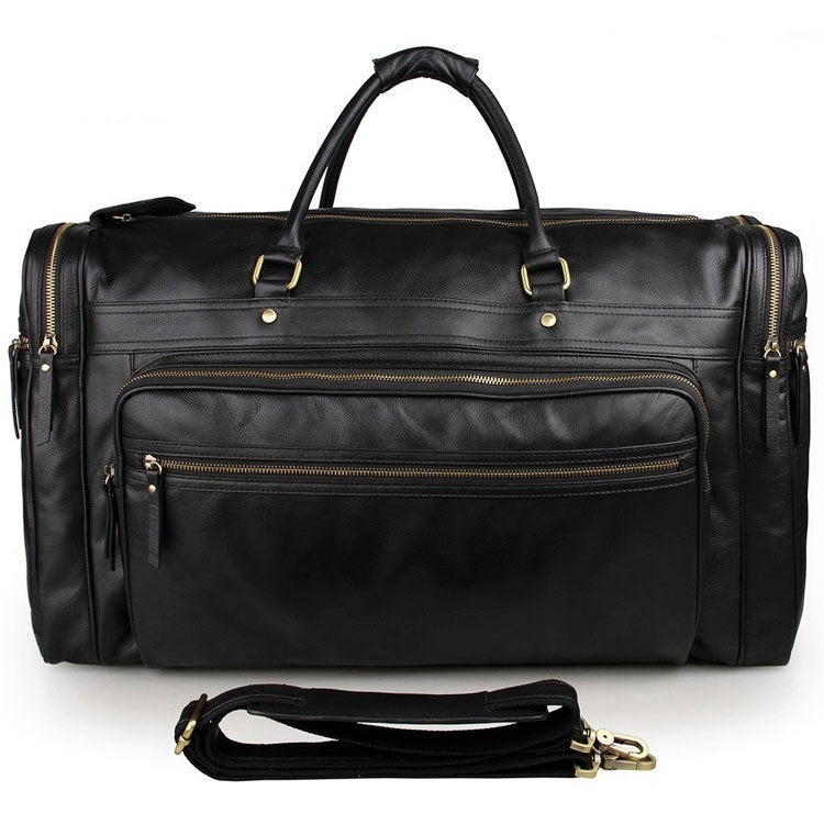 Black leather duffel bag with gold zippers on a white background