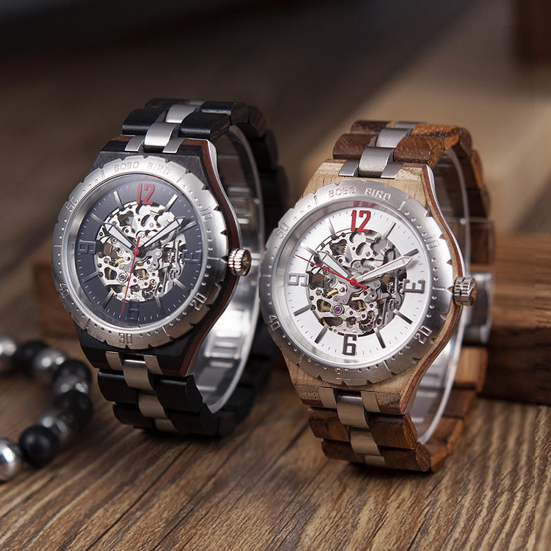 Two wooden watches with metal straps on a wooden surface