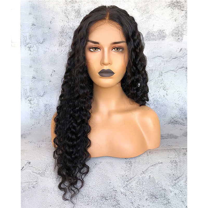 Mannequin head with long black wavy wig on a textured gray background
