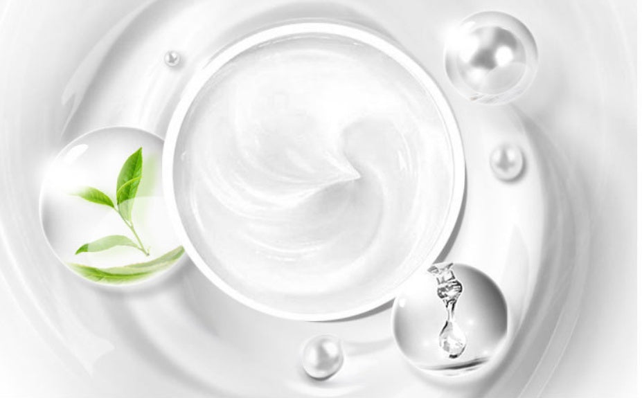 White cream with green leaf and water droplets on a white background