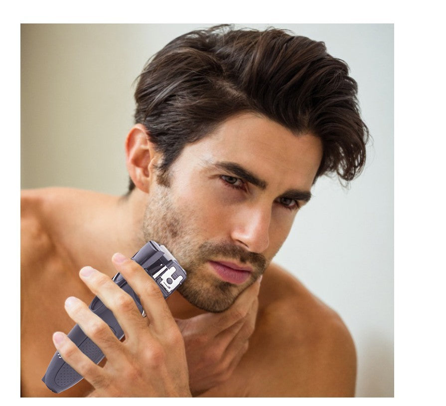 Man using a hair trimmer on his face with a neutral background