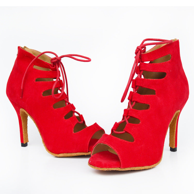 Red high-heeled shoes with cut-out design on a white background