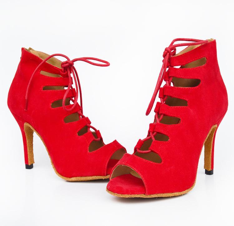 Red high-heeled shoes with cut-out design on a white background