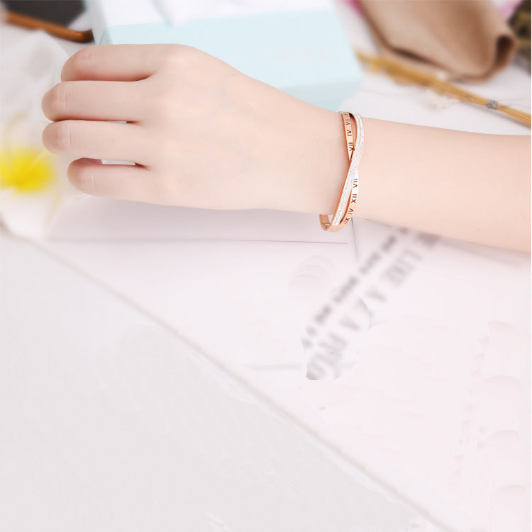 Rose gold bracelet on a wrist with a blurred background