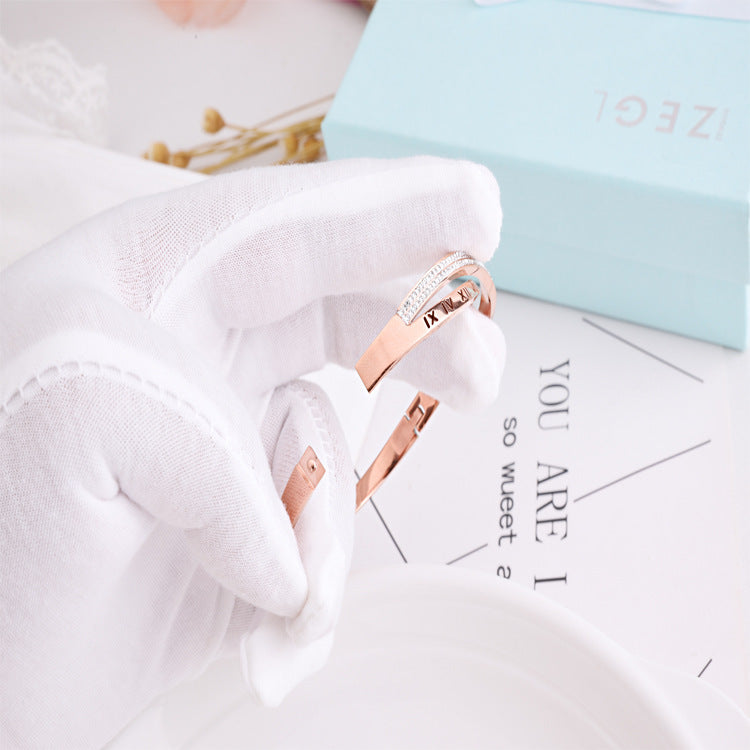 Rose gold ring on a white surface with text