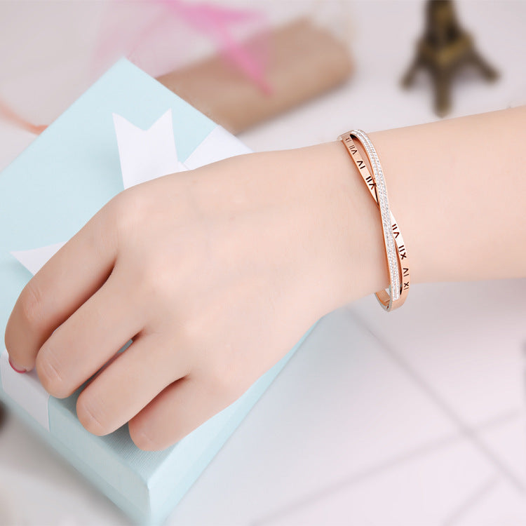 Rose gold bracelet on a child's wrist with a soft focus background