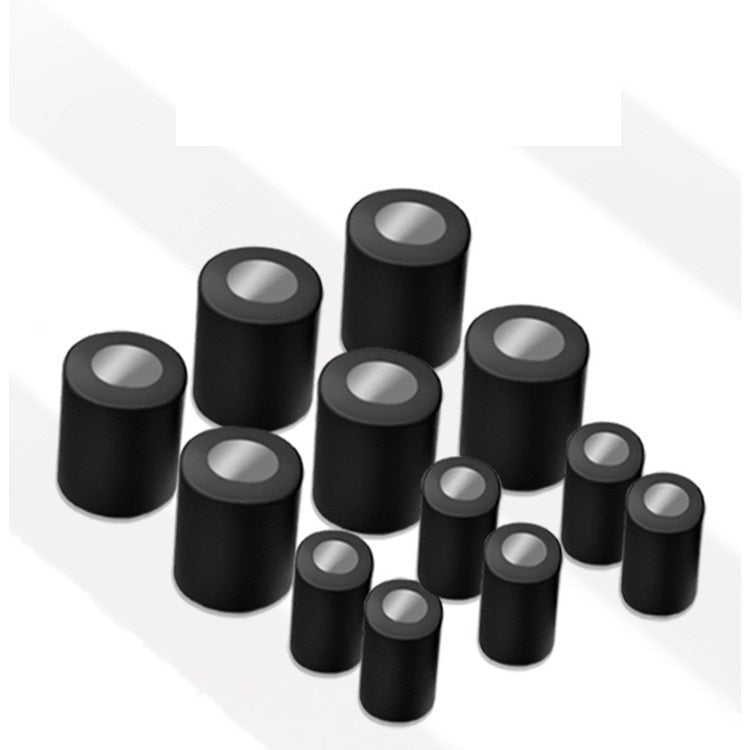 Set of black cylindrical objects on a white background