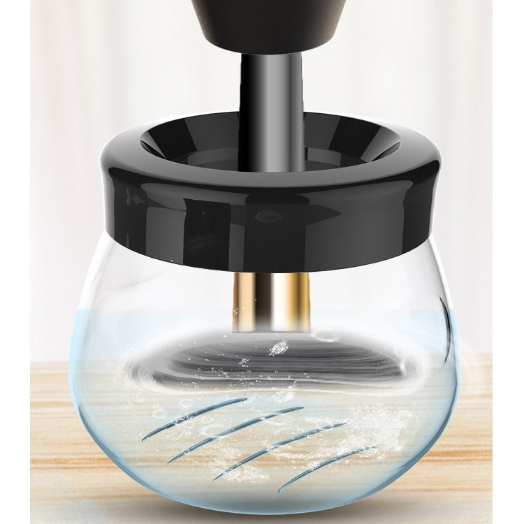 Glass container with black lid on a light background