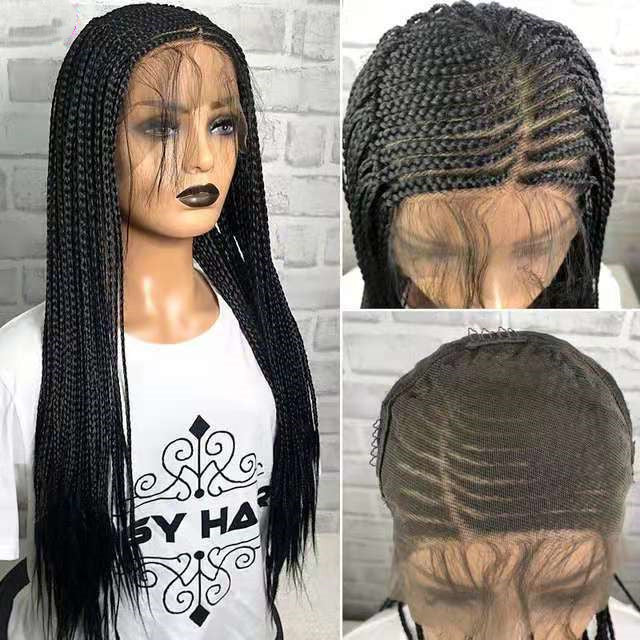 Black braided wig on a mannequin head with close-up details against a gray brick wall.