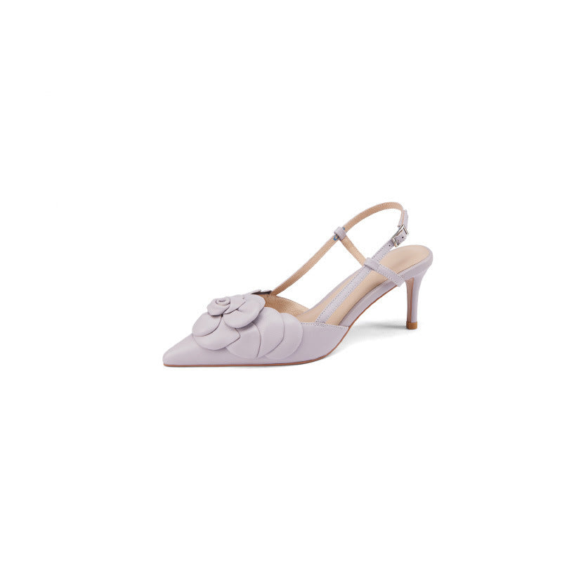 White high-heeled shoe with floral design on a white background
