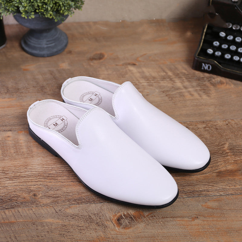 White slippers on a wooden surface with a typewriter in the background
