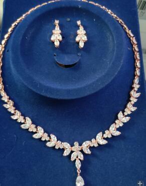 Jewelry set with necklace and earrings on a blue stand