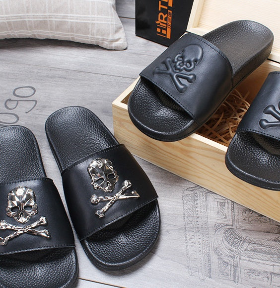 Black slides with skull and crossbones design on a wooden block
