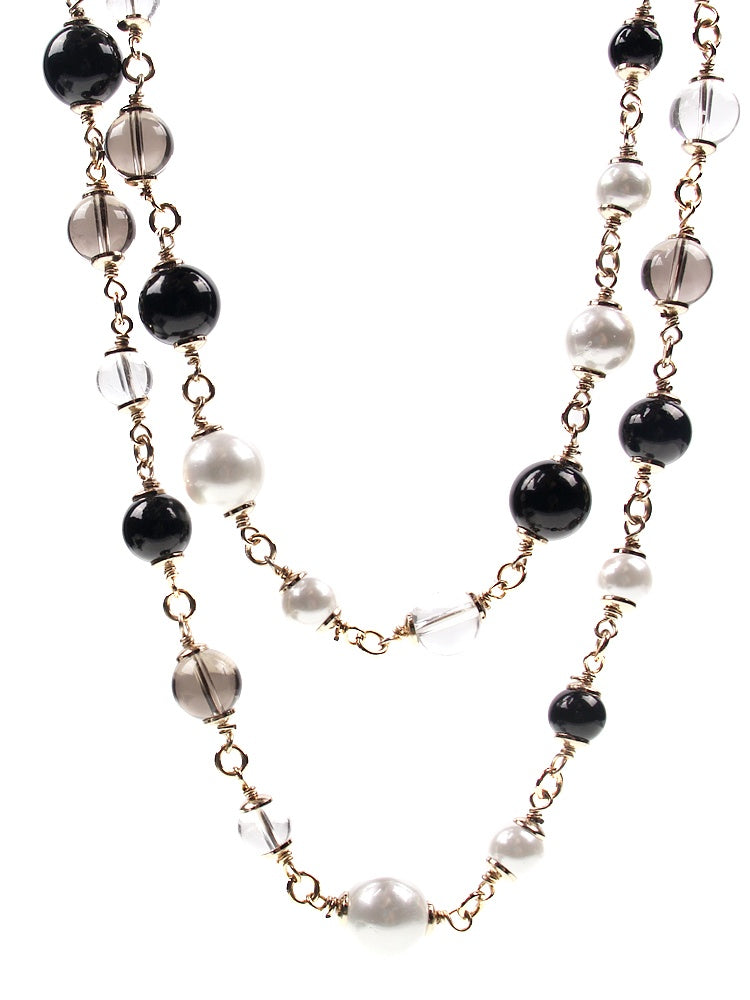 Necklace with black, white, and clear beads on a white background