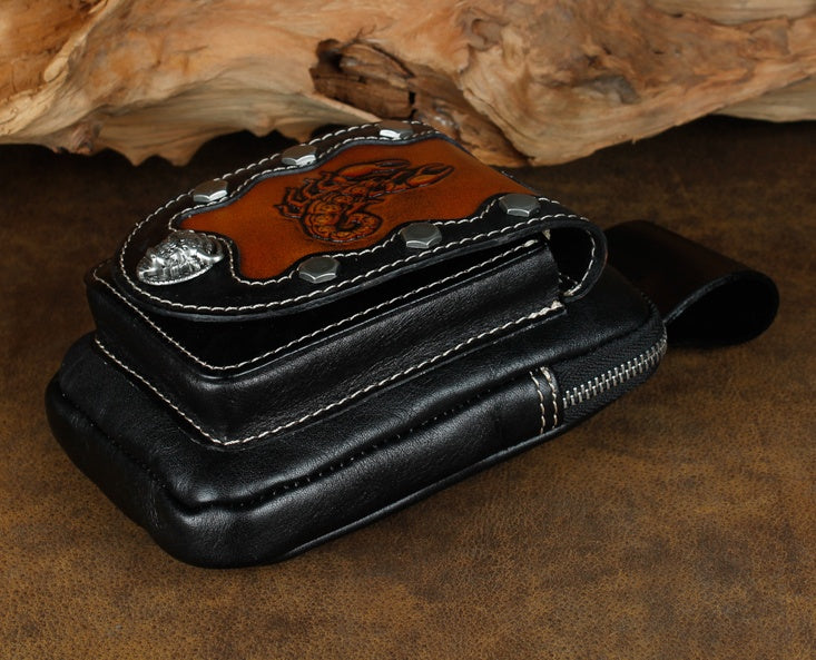 Black leather wallet with brown leather patch on a wooden surface