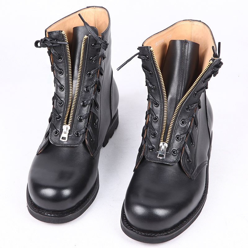 Pair of black leather boots with zipper details on a white background