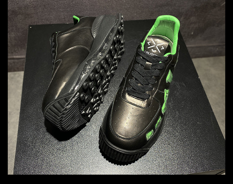 Black and green shoes on a black surface with a dark background