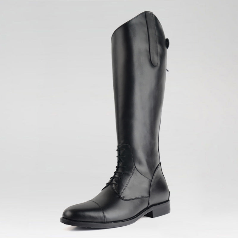 Black riding boot on a light gray background