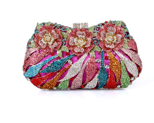 Colorful floral clutch bag with intricate design on a white background