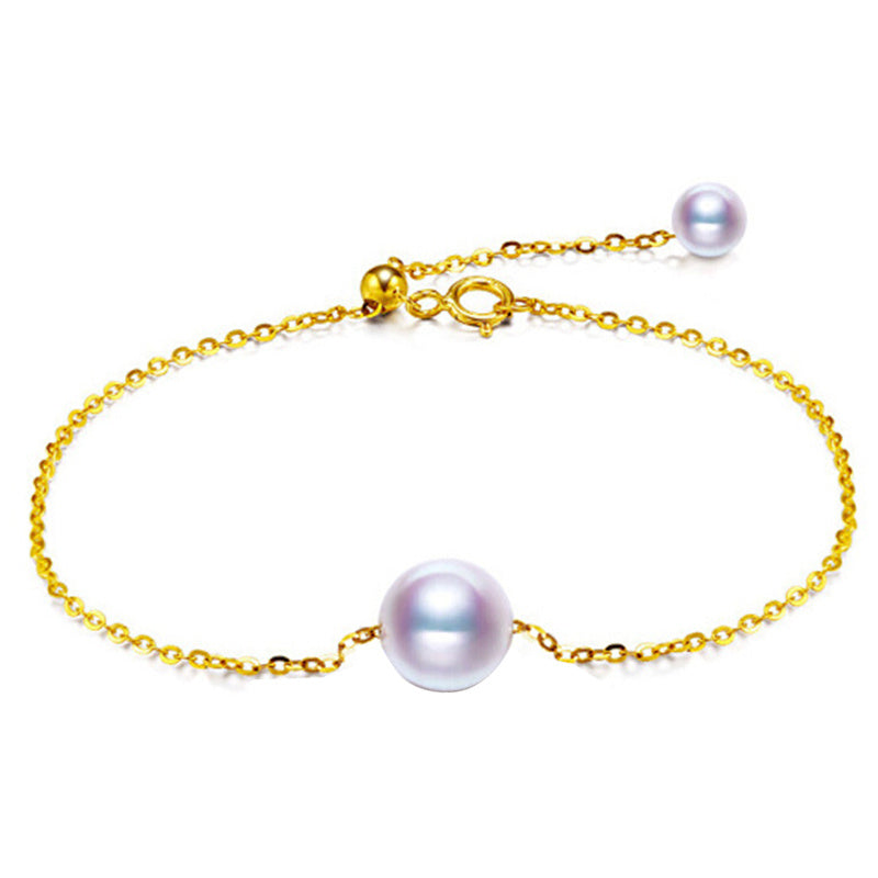 Gold bracelet with pearls on a white background