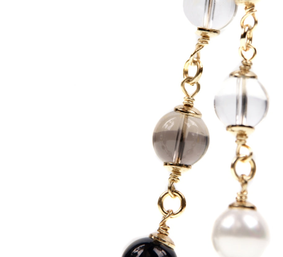 Earrings with gold wire wrapping and multicolored beads on a white background