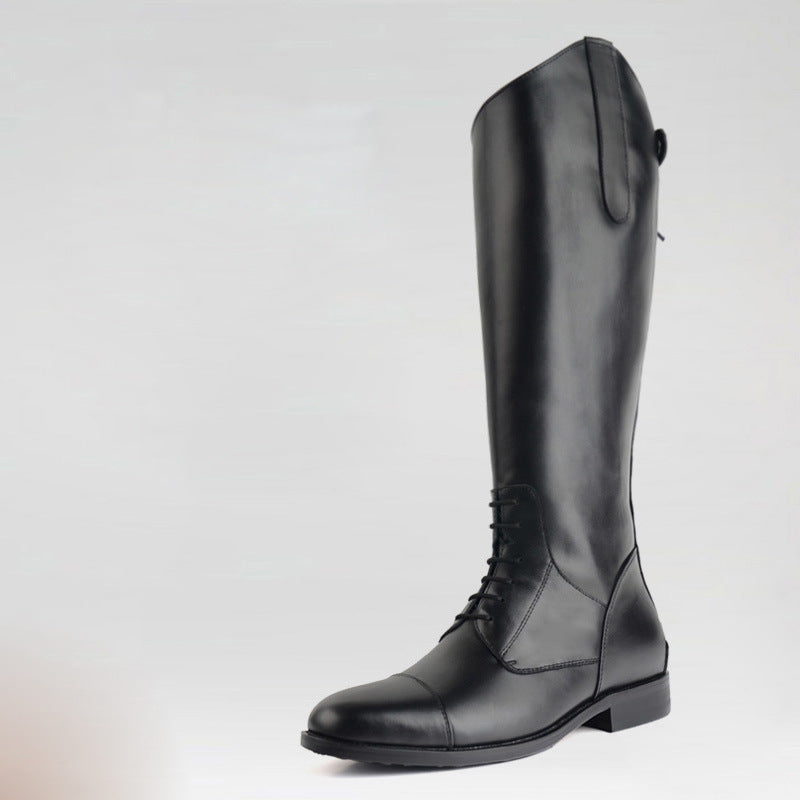 Black riding boot on a light gray background