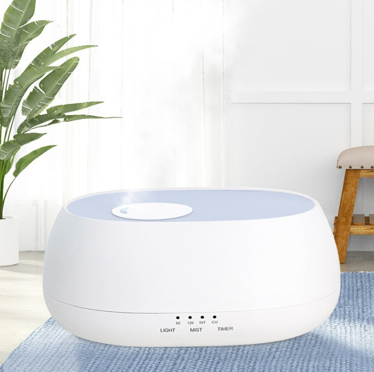 White and blue humidifier on a blue rug with a plant in the background
