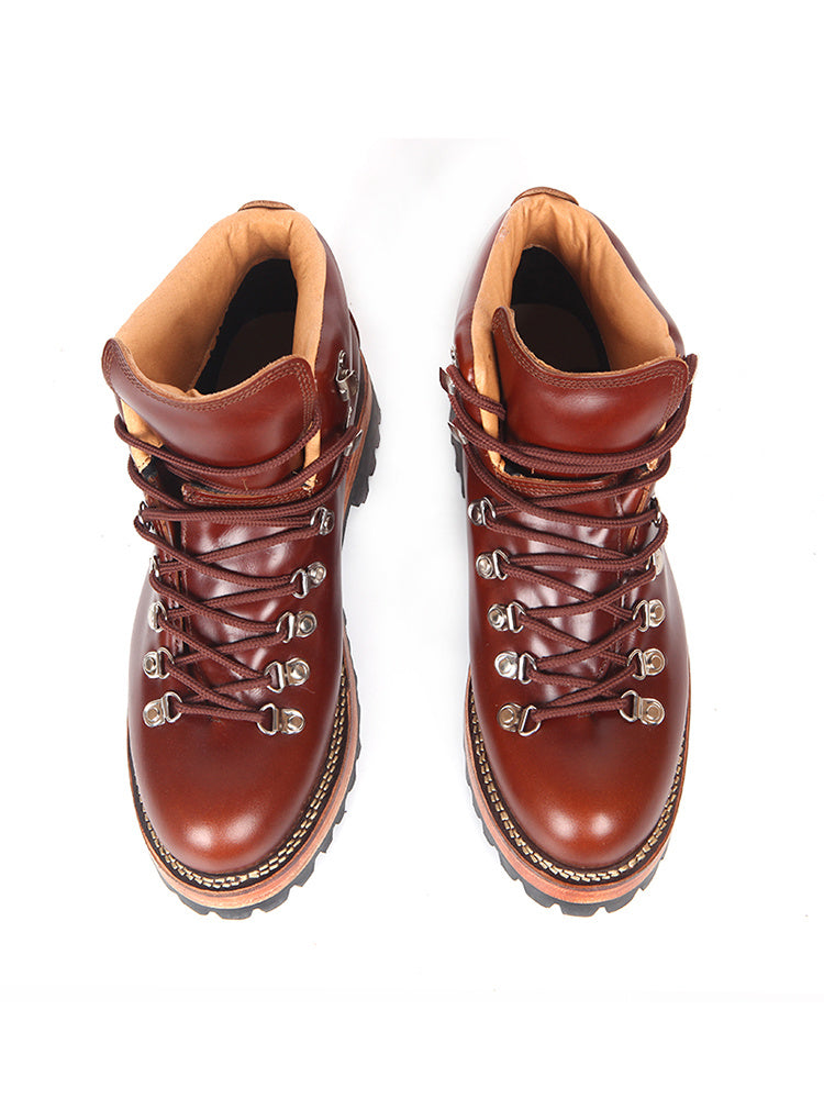 Pair of brown leather boots with laces on a white background