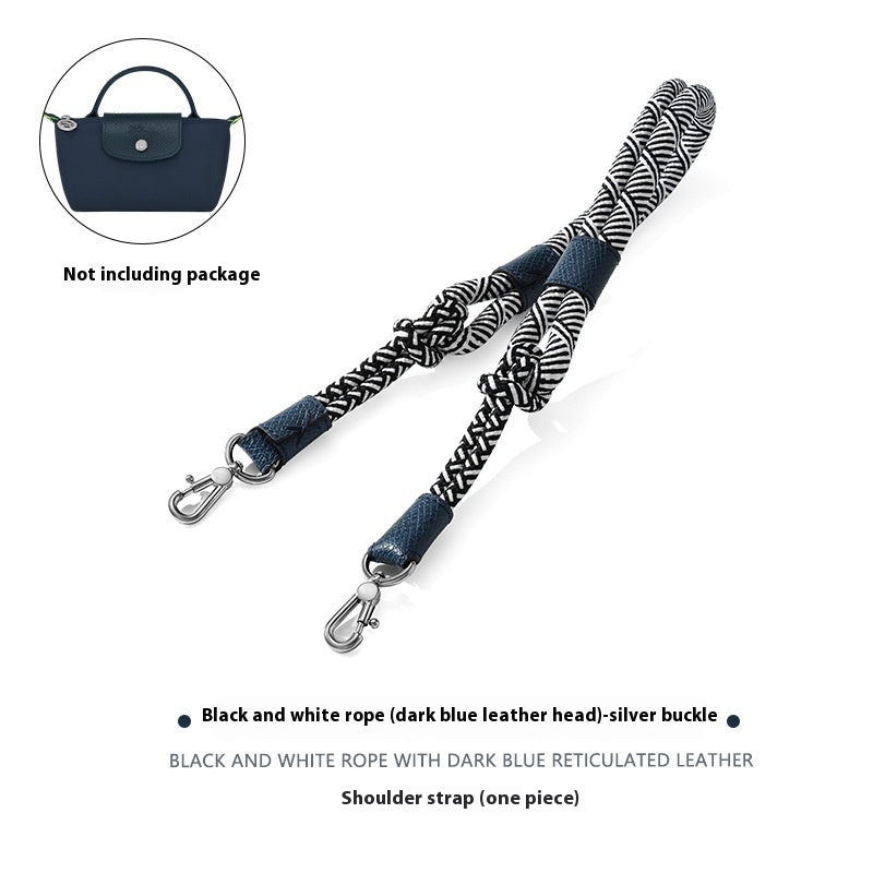 Black and white rope shoulder strap with dark blue leather head and silver buckle on a white background.