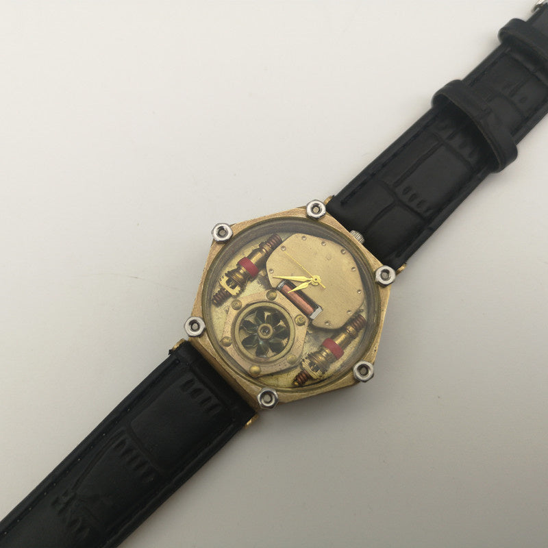 Mechanical watch with black strap on a light gray background