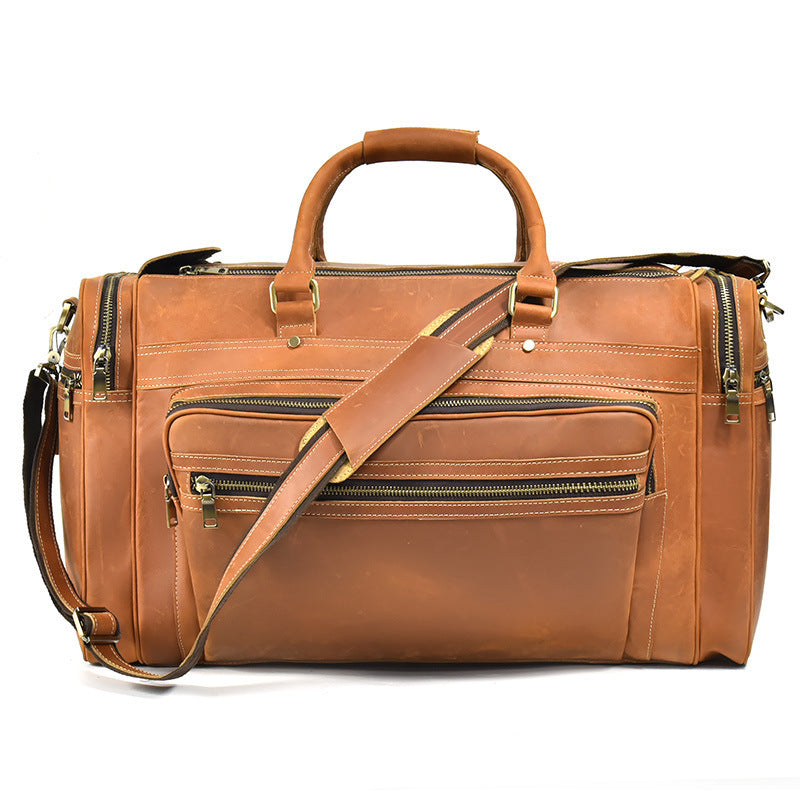 Brown leather duffel bag with multiple zippers on a white background