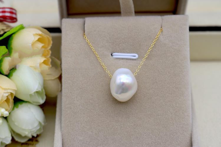 Pearl necklace on a display card with flowers in the background