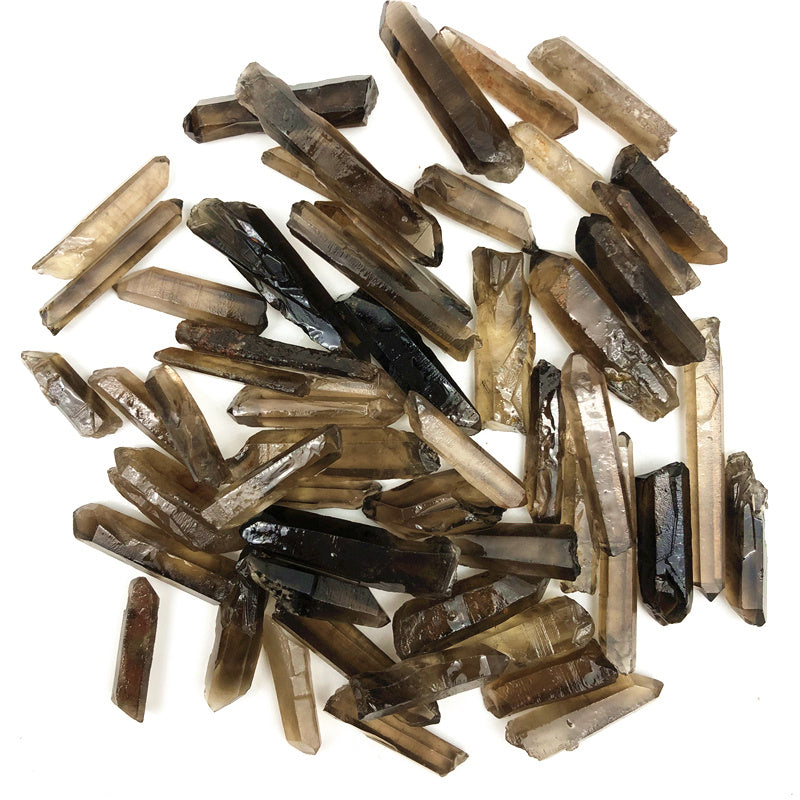 Collection of brown crystal sticks on a white background