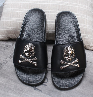 Black slides with skull and crossbones design on a gray surface.
