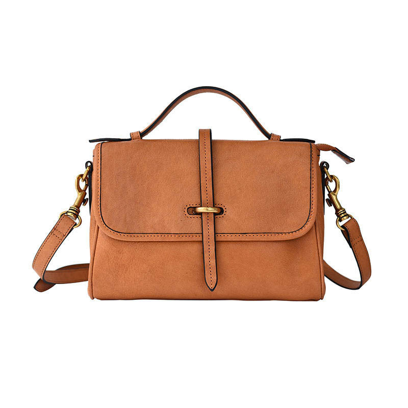 Brown leather handbag with gold accents on a white background