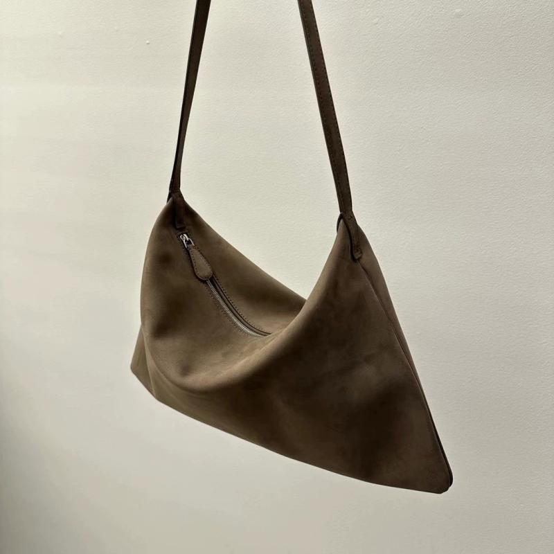Brown leather shoulder bag on a light beige background