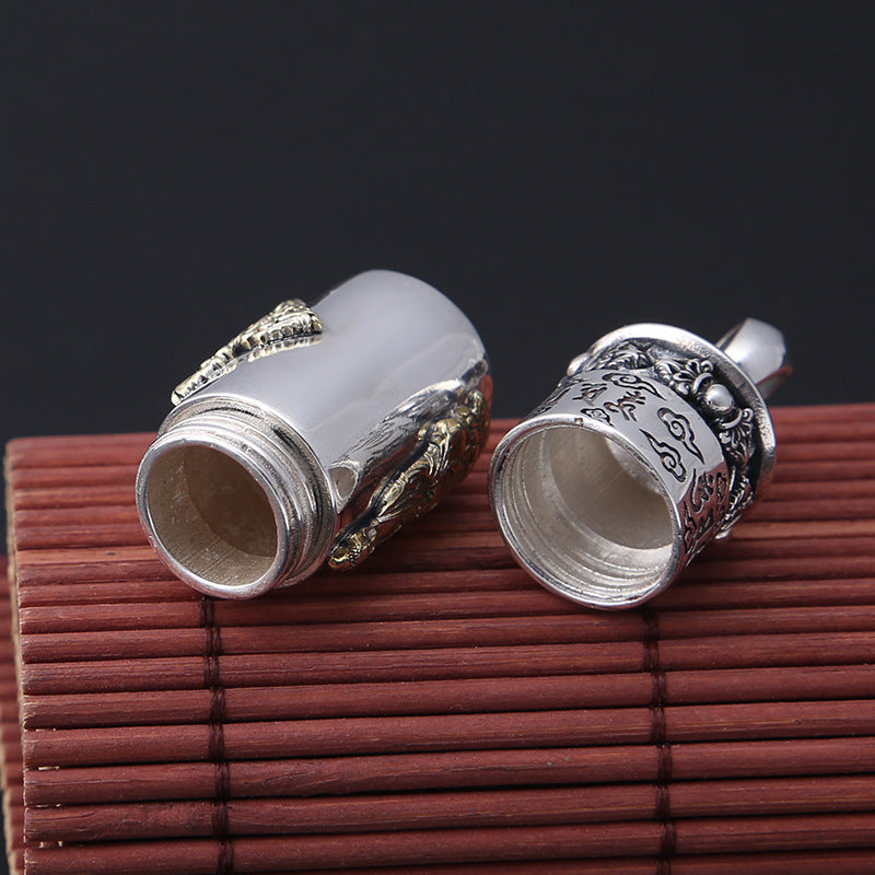 Silver cufflinks with intricate designs on a wooden surface