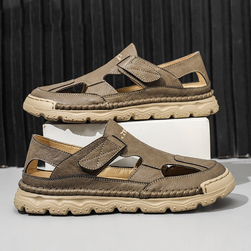 Pair of brown sandals with beige soles on a black background