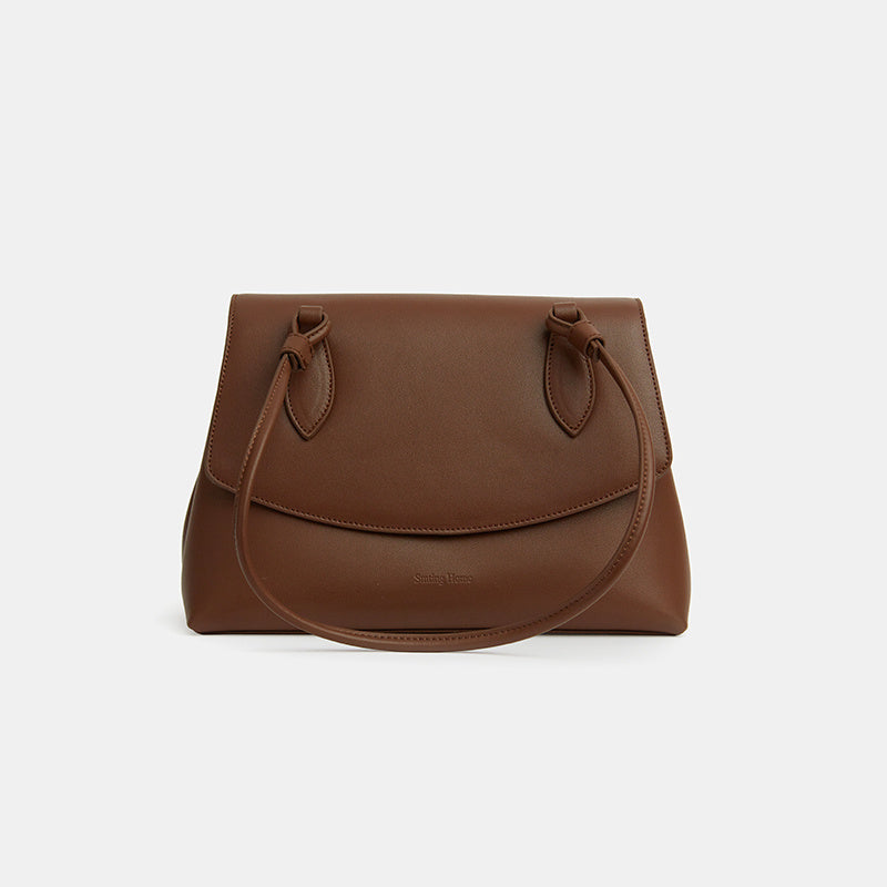 Brown leather handbag on a white background