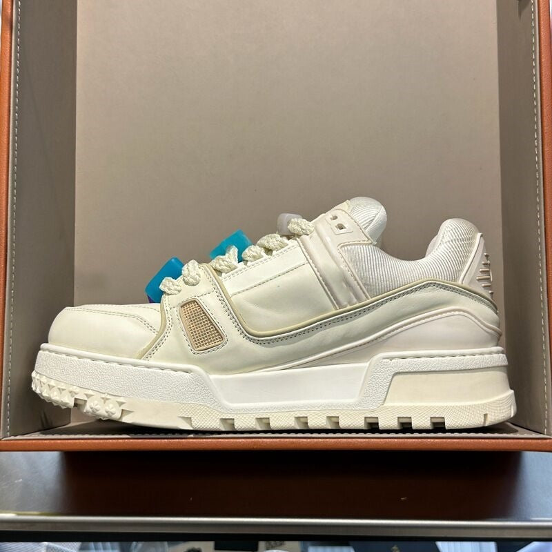 White sneaker with blue laces in a box