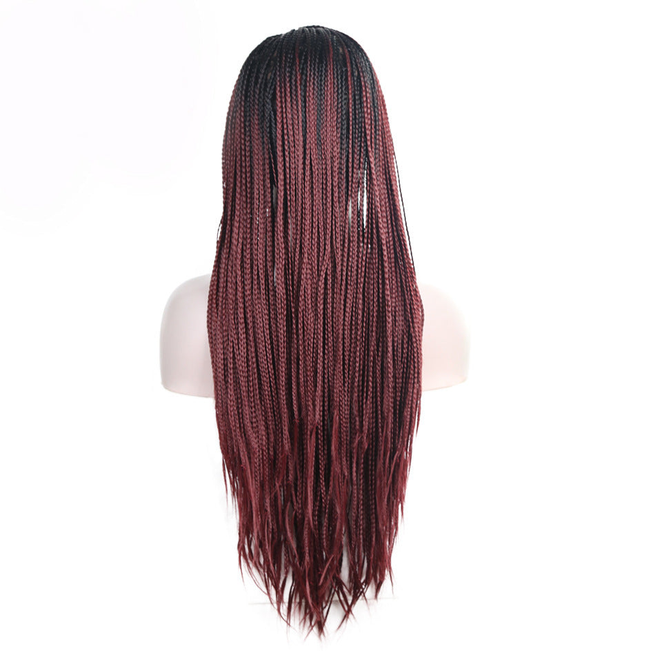 Red and black braided wig on a white mannequin head with a white background
