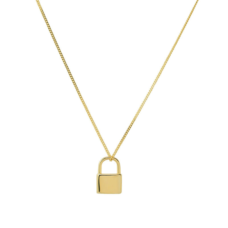 Gold padlock necklace on a white background