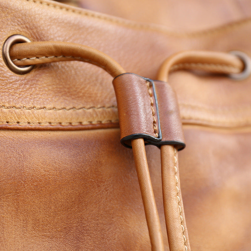 Close-up of a brown leather bag with handles