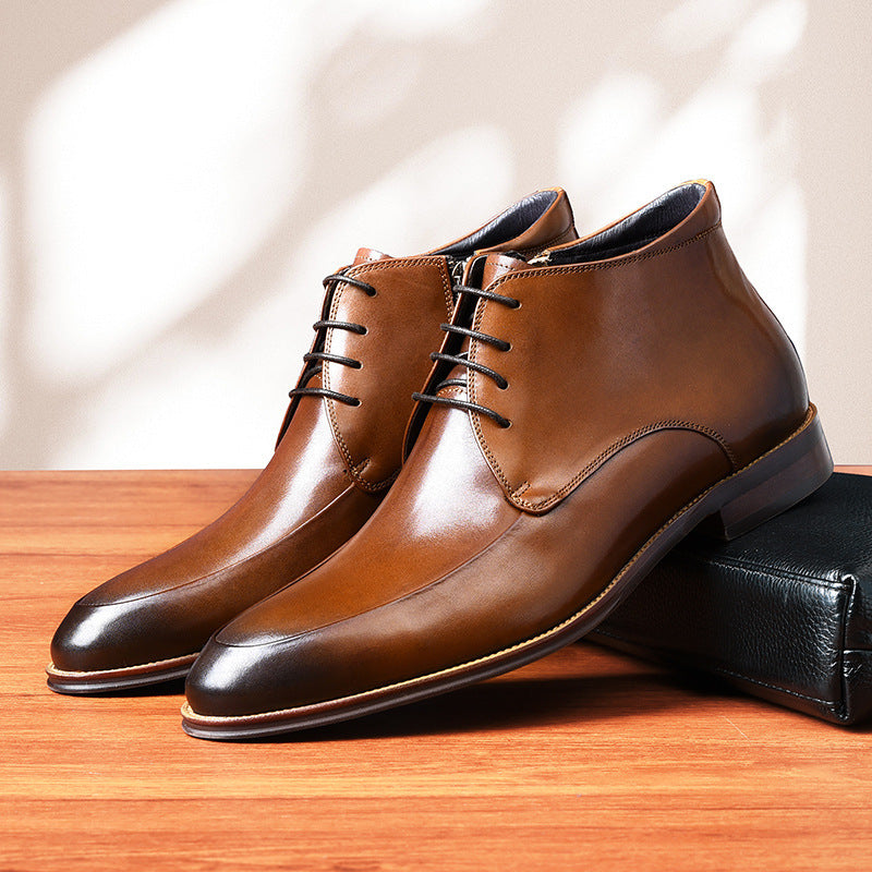 Pair of brown leather dress shoes on a wooden surface with a neutral background