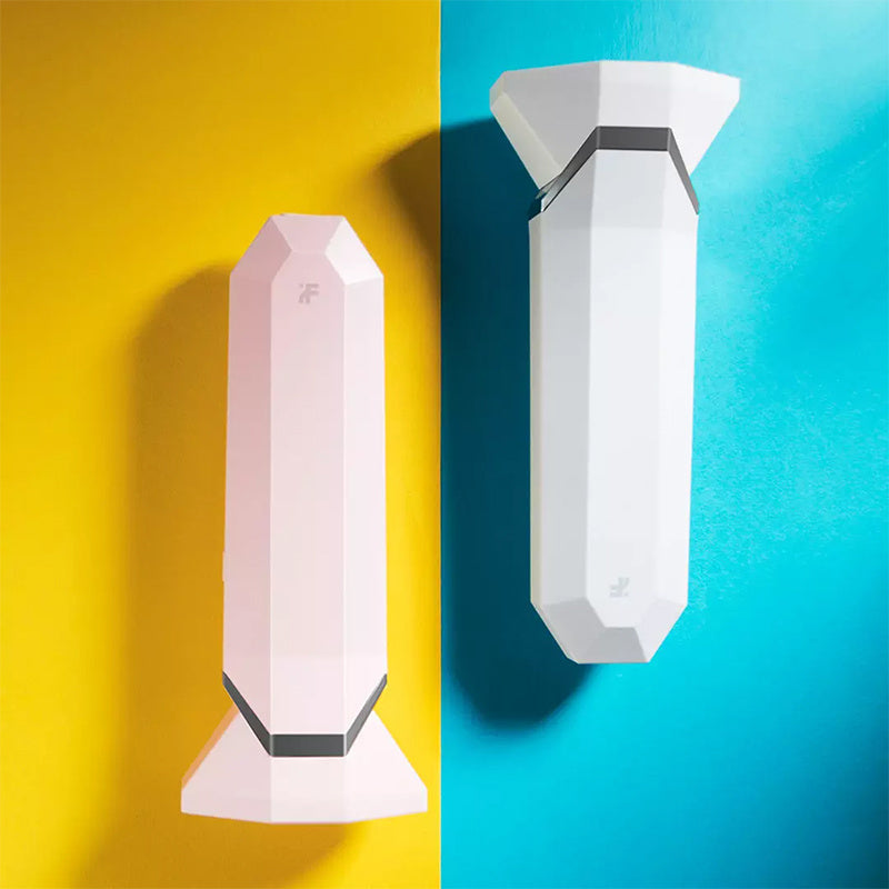 Two geometric wall lights, one pink and one white, on a yellow and blue background.
