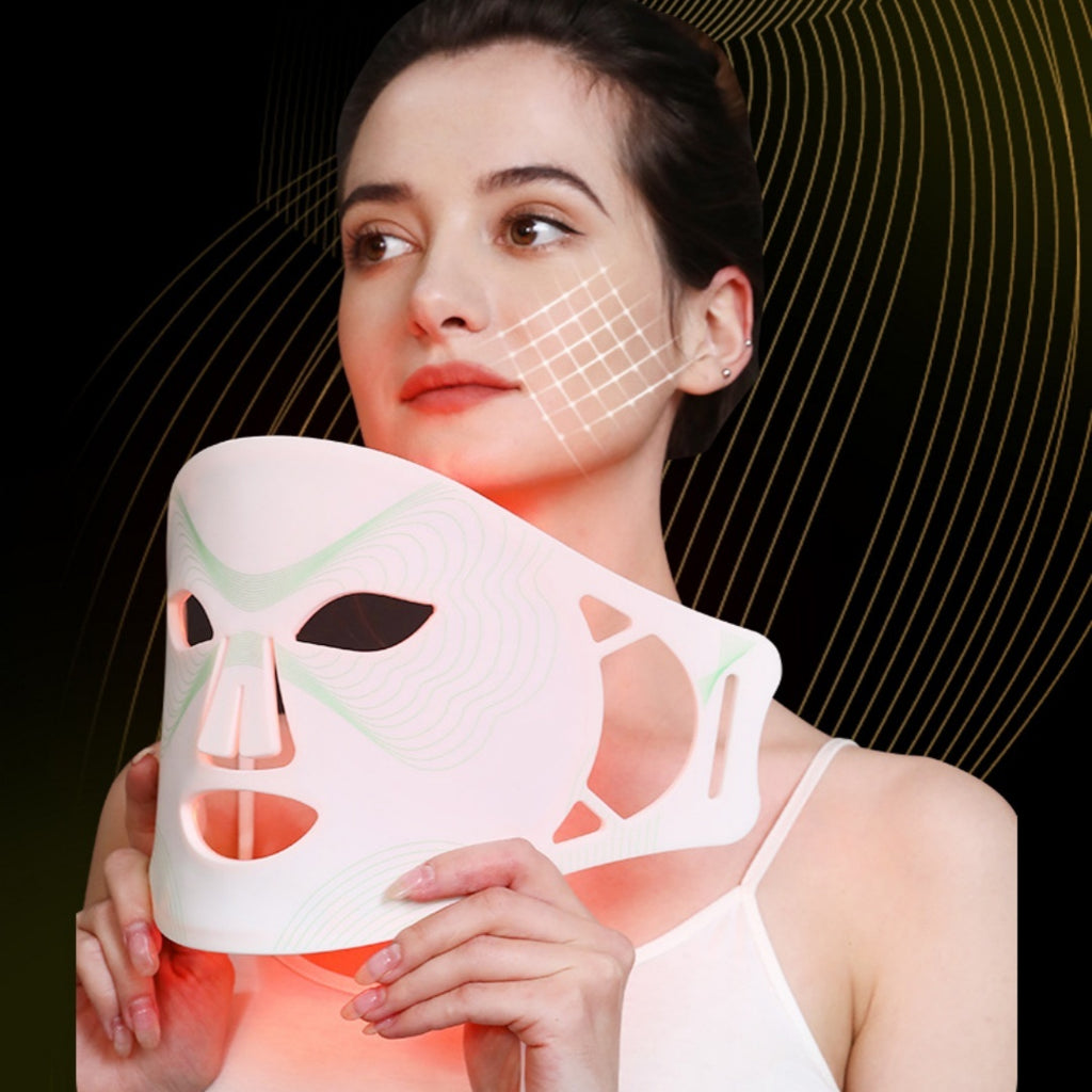 Woman holding a LED face mask with a black background