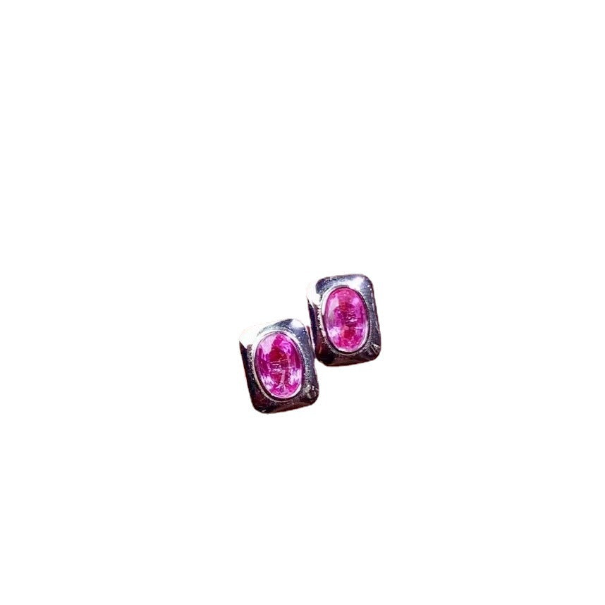 Pair of pink gemstone stud earrings on a white background