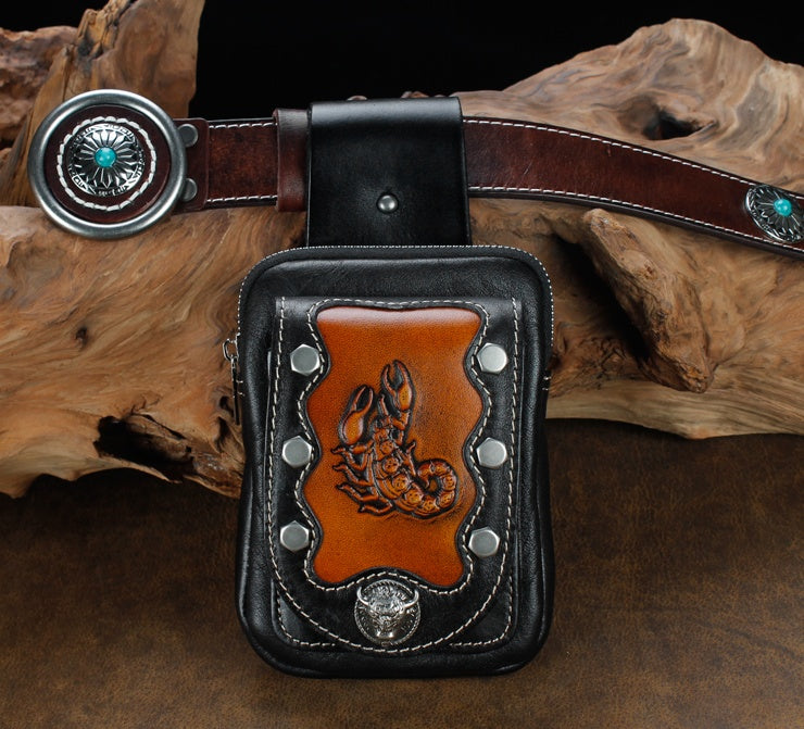 Leather pouch with lobster design on a wooden surface