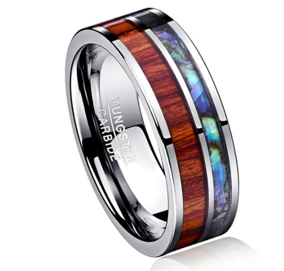Tungsten carbide ring with wooden and abalone shell inlay on a white background